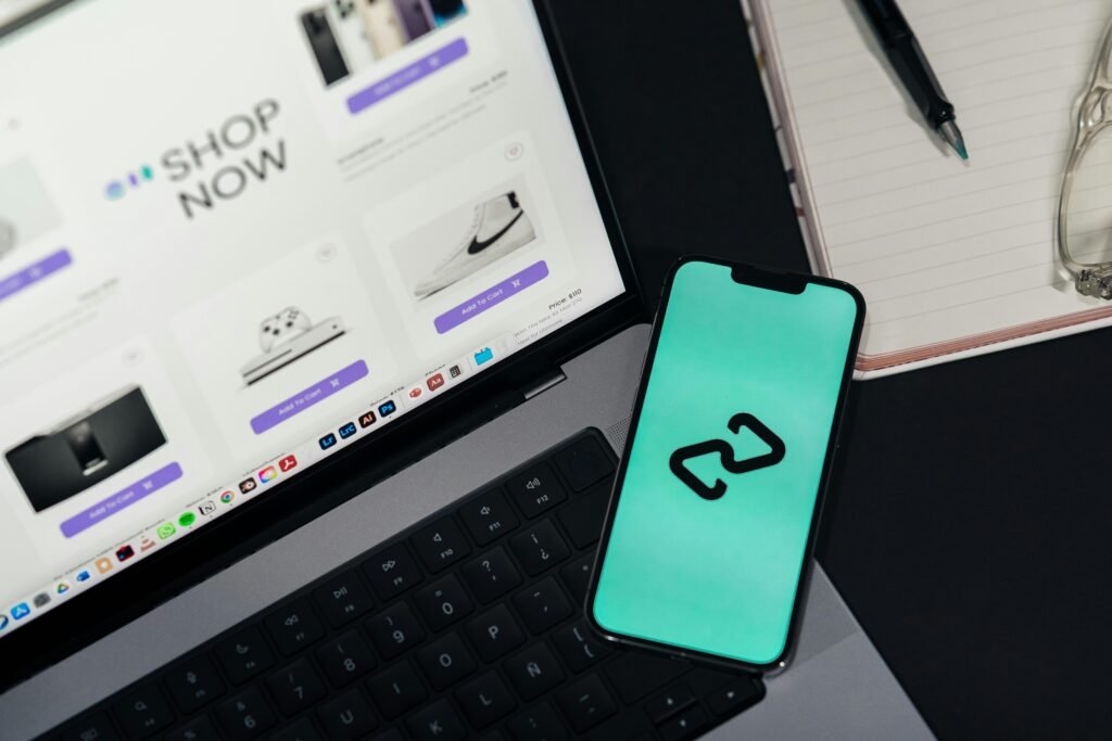 oil-1 A smartphone and laptop displaying online shopping platforms, suggesting digital retail.